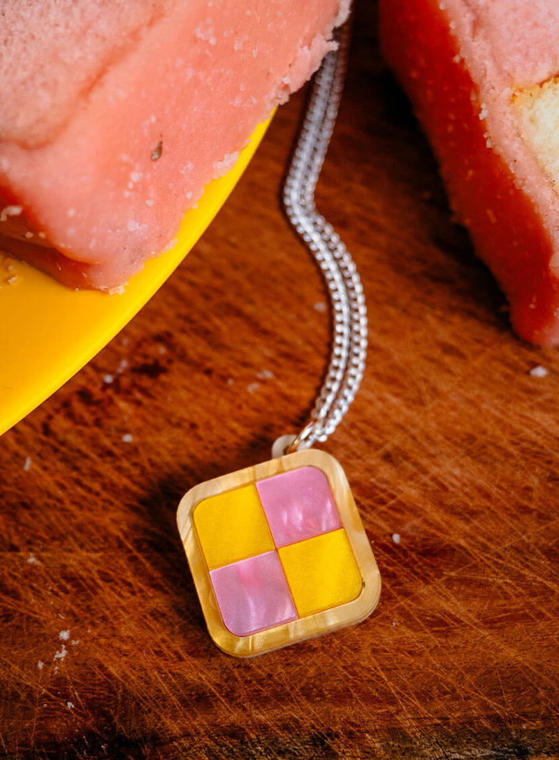 Close up detail of the Battenberg Cake Pendant handmade from pearlescent pink and yellow acrylic