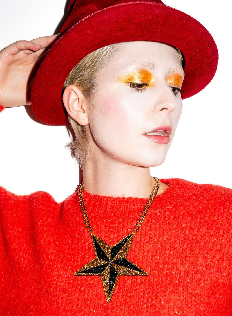 Large black and gold glitter star necklace made from acrylic