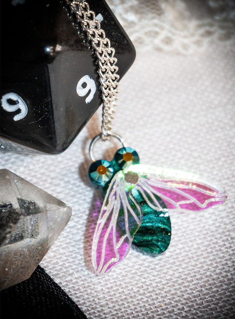 Close up of our Greenbottle Fly Pendant with Iridescent Wings showing pearlescent acrylic body