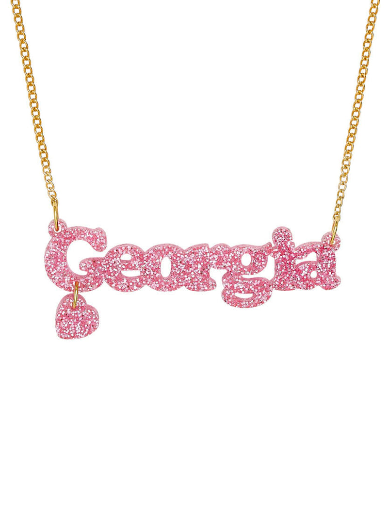 Personalised Name Necklace in limited edition Pink Glitter on a gold chain. it reads 'Georgia' and has a heart shaped charm.
