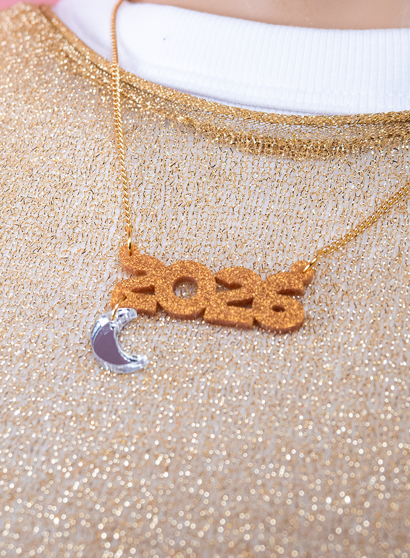 Custom Name Necklace with '2026' and crescent moon charm on a glittery top.