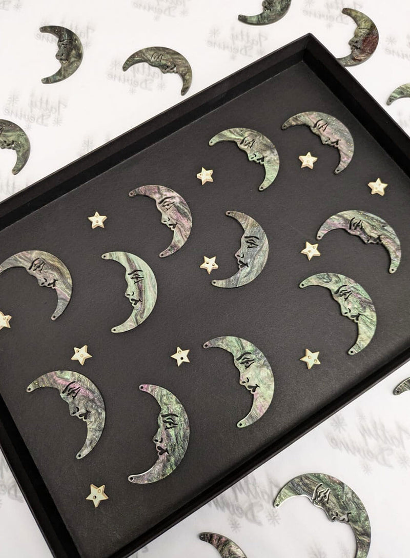 La Luna moon acrylic moons by Tatty Devine showing the variety of acrylic swirl