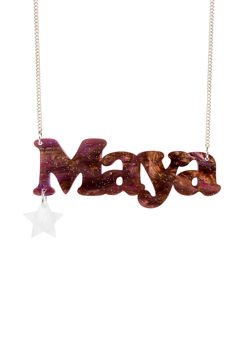 A personalised Name Necklace spelling 'Maya' in limited edition Astral Swirl acrylic, hanging from a silver chain, with a small white star charm below the first letter, on a plain white background.