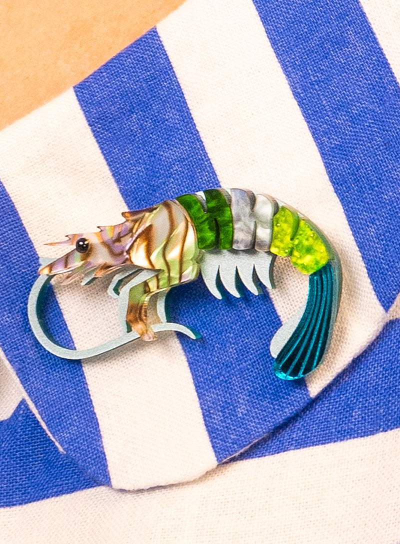 Green Pearly Prawn Brooch worn on blue and white stripes
