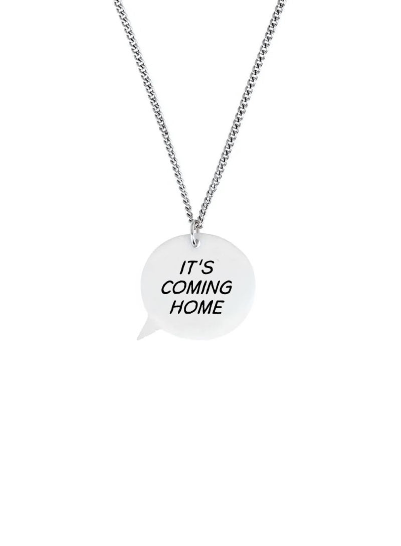 A silver chain necklace with a white speech-bubble pendant that reads 'IT'S COMING HOME' in black text, shown on a plain white background.