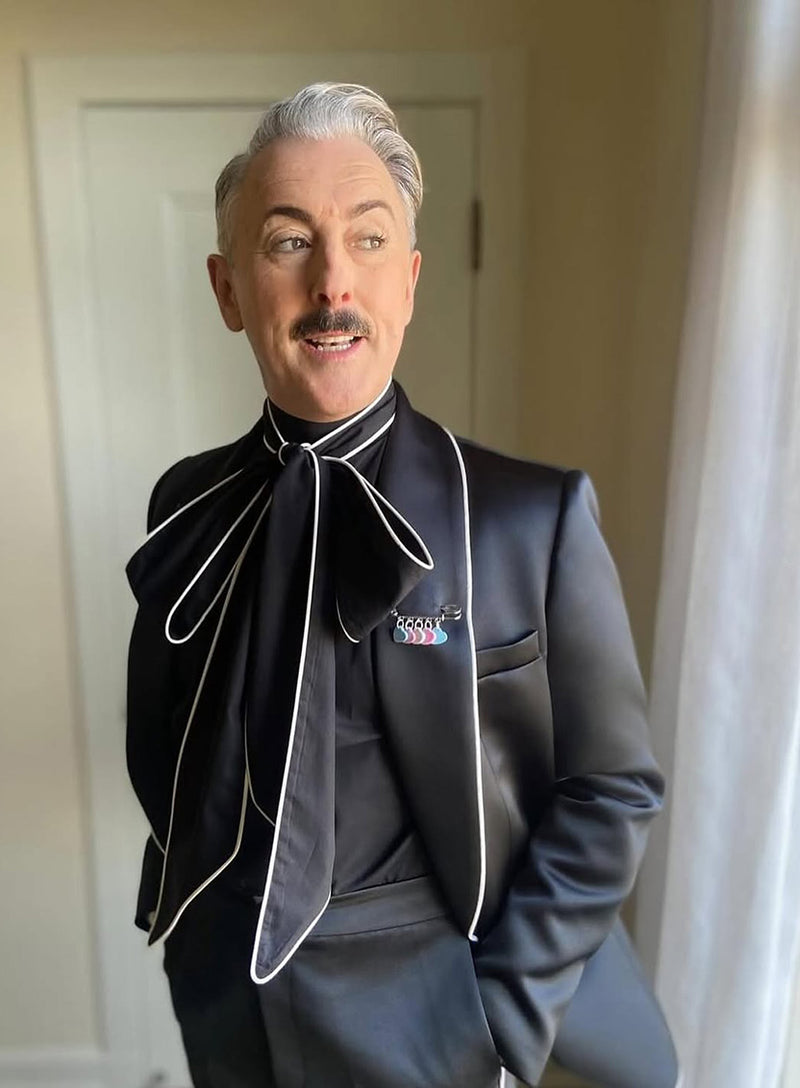 Alan Cummings wearing the Tatty Devine x Not A Phase Trans Pride Kilt Pin.