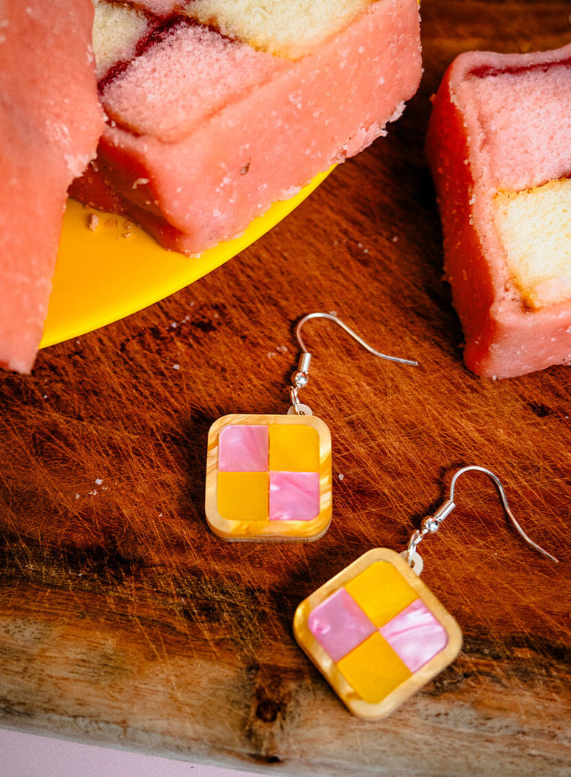 Detail of the Battenberg Cake Earrings handmade from pearlescent pink and yellow acrylic