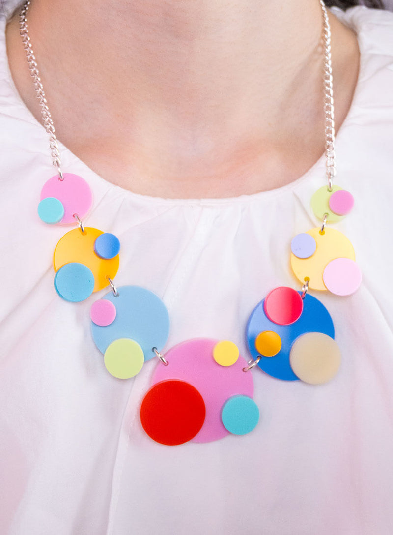 Close up detail of the colourful circles on our Colourful Dots Statement Necklace