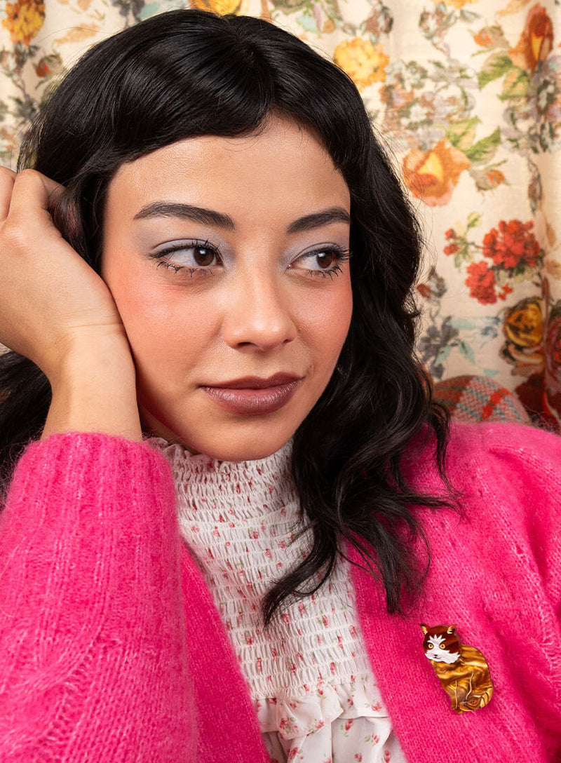 Brown Tortoiseshell Cat Brooch worn with a pink fluffy cardigan