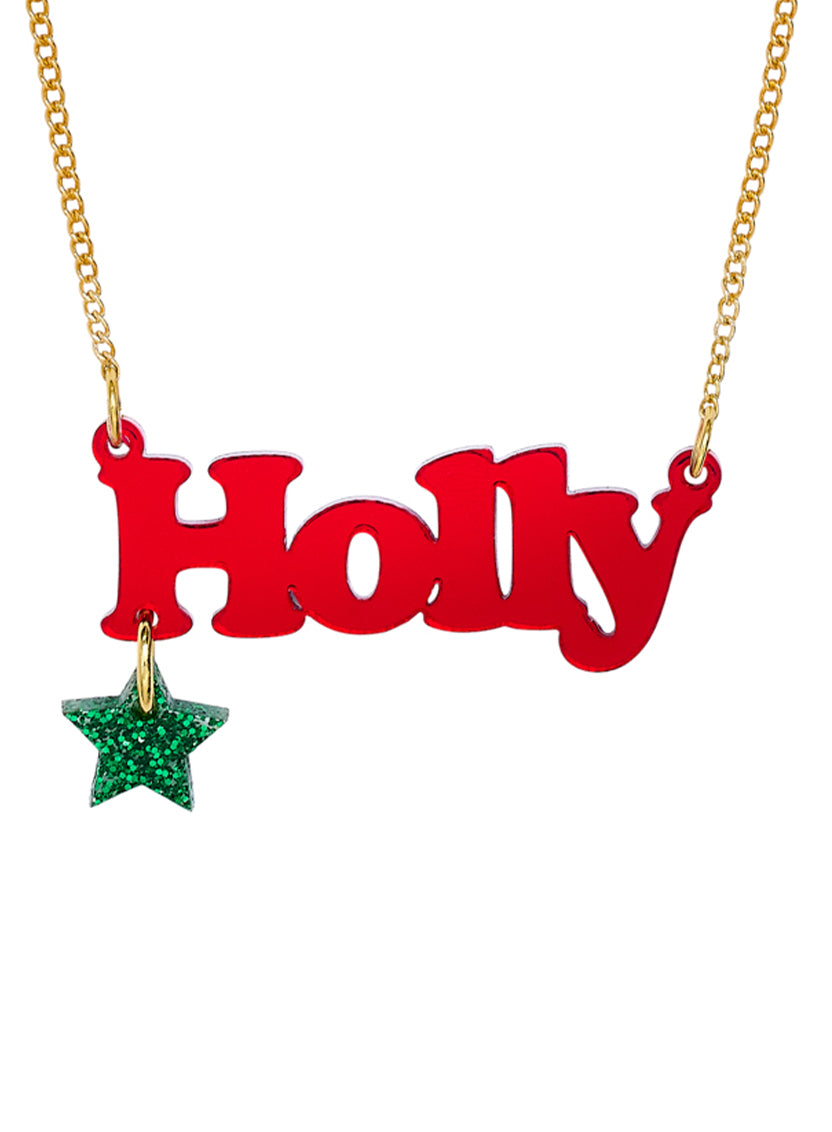 Red 'Holly' personalised Name Necklace with a green star pendant on a gold chain against a white background.