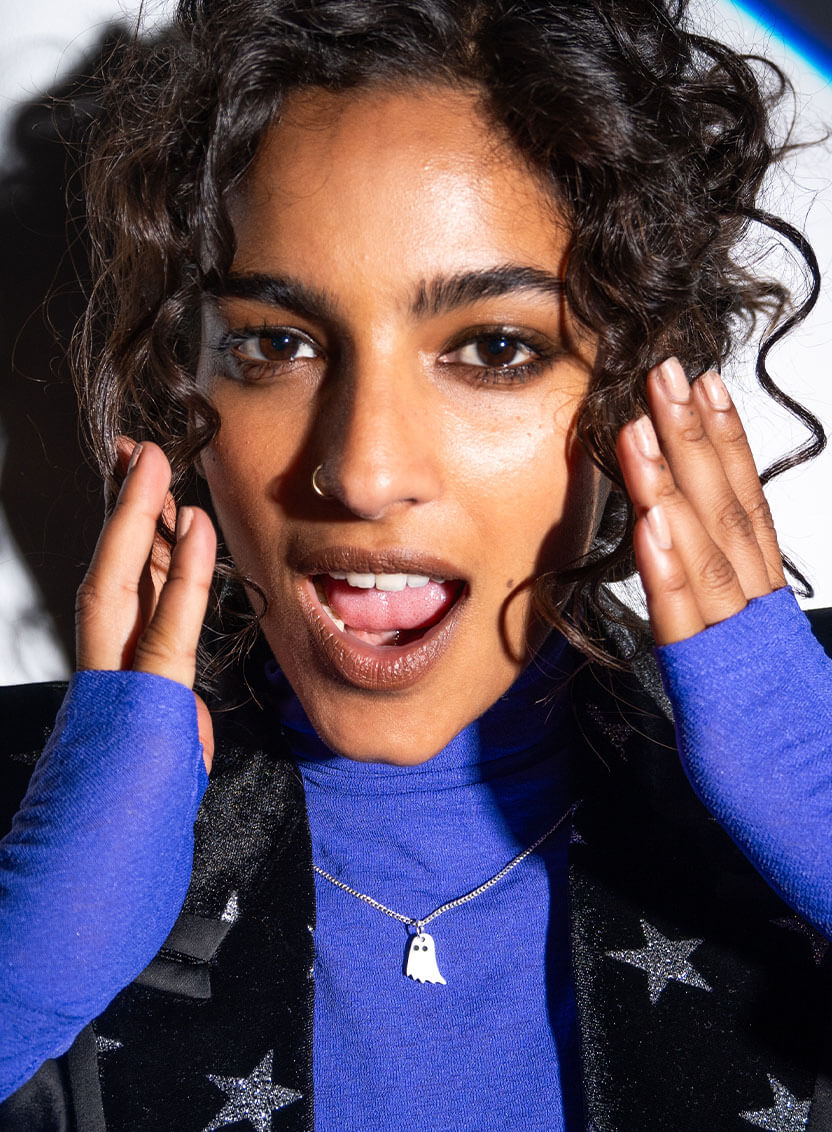 Words saying 'A Tatty Devine Ghost Walk' with white ghosts and gold text on a dark background.