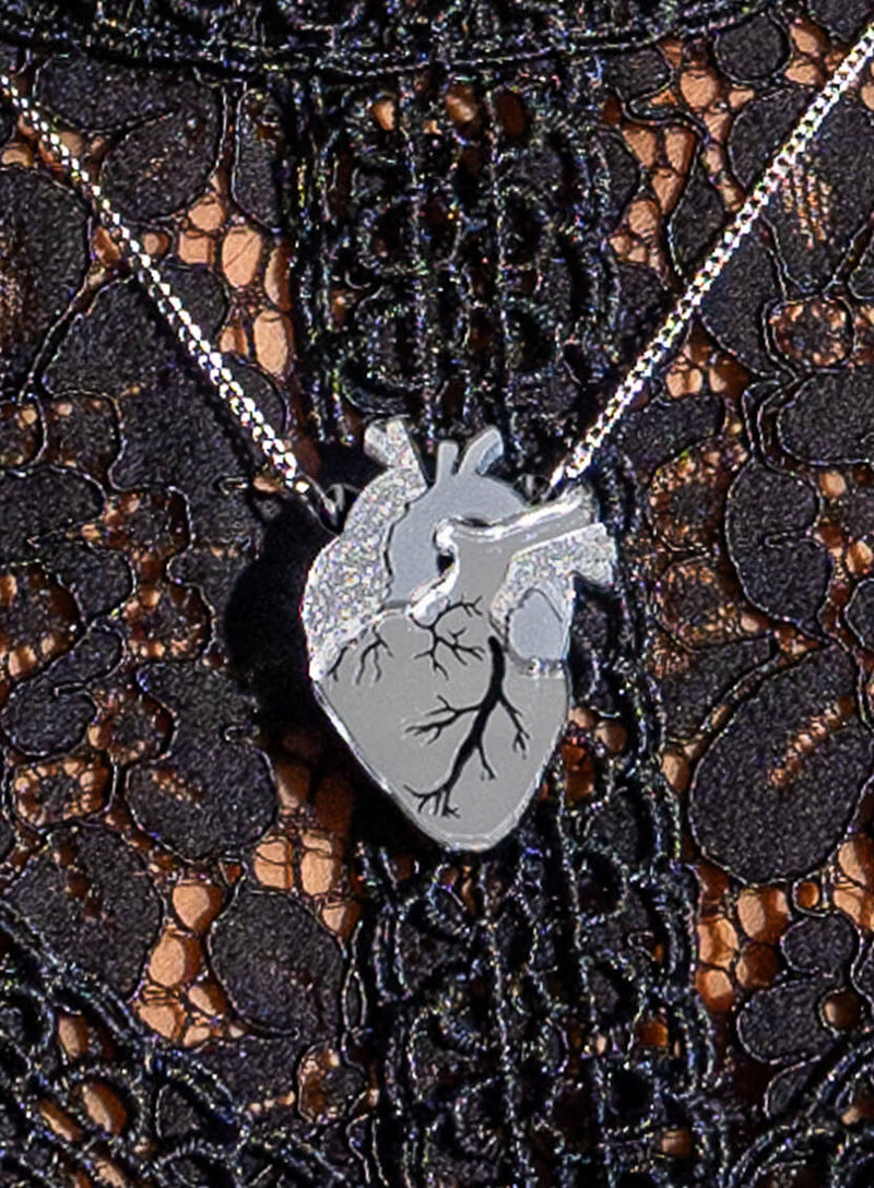 Anatomical Heart Necklace - Silver worn over a black lace top