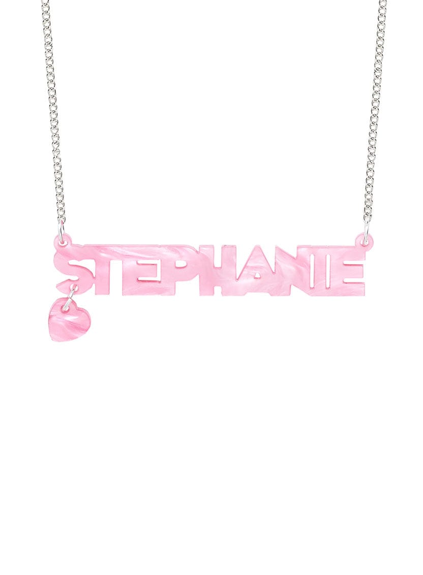 Tatty Devine Name Necklace with a heart shaped charm in recycled pink pearl. The name says: Stephanie.