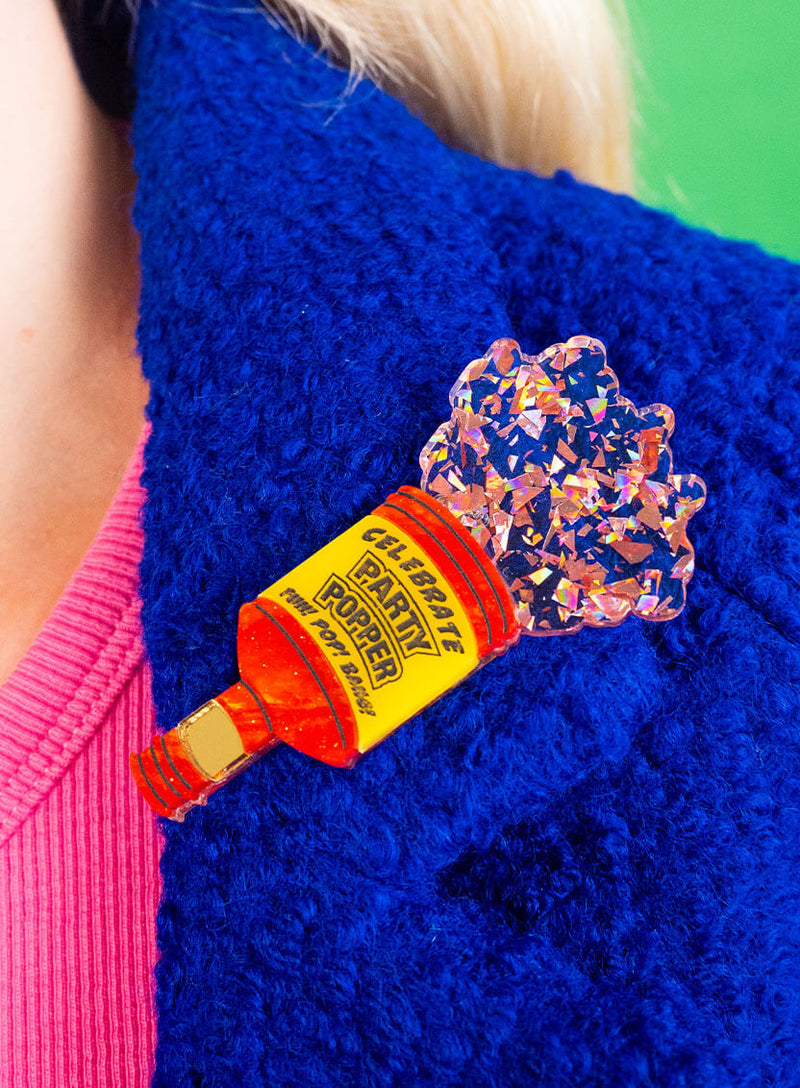 Party Popper Brooch worn on a blue winter coat